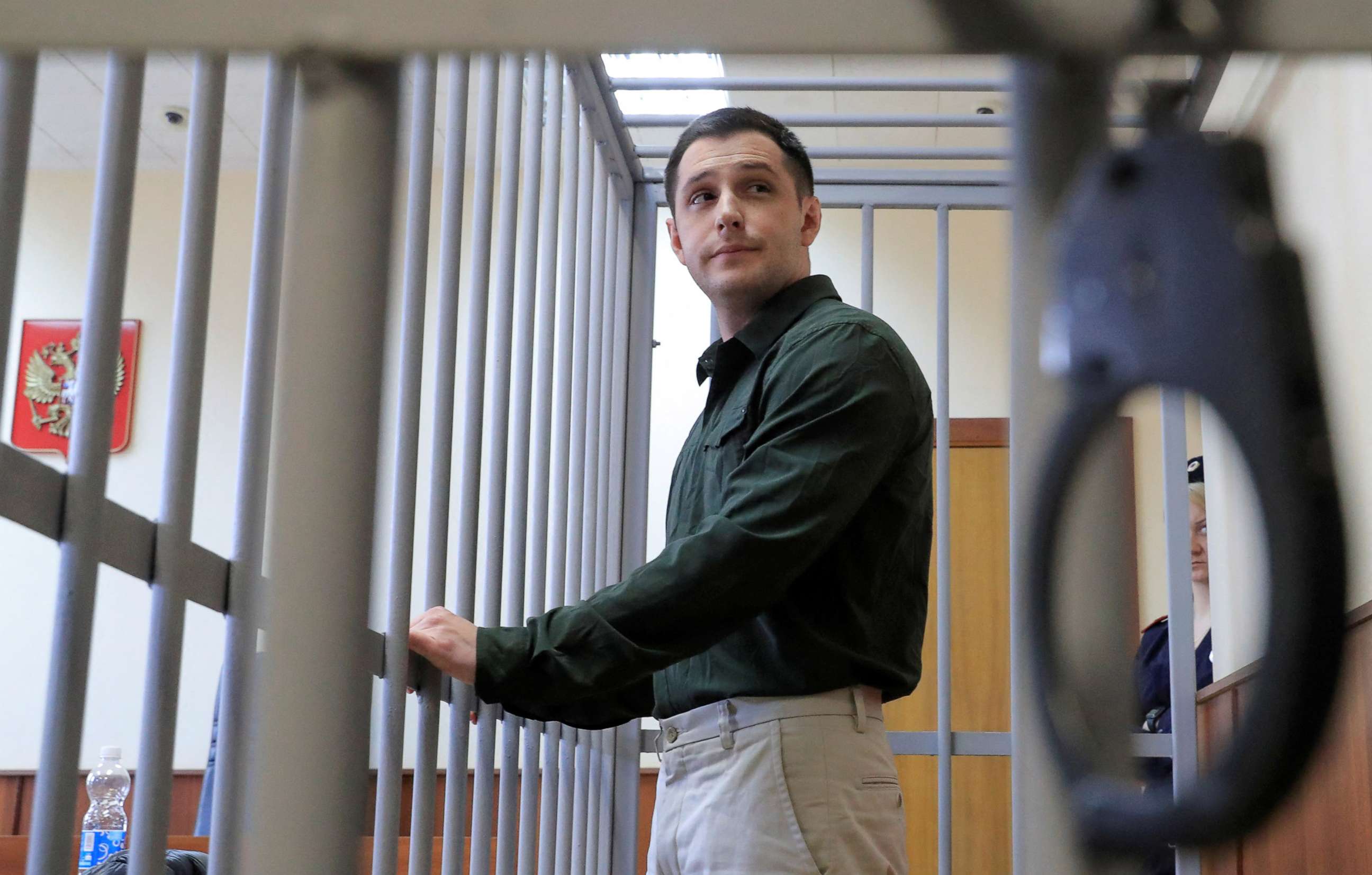 PHOTO:U.S. ex-Marine Trevor Reed, who was detained in 2019 and accused of assaulting police officers, stands inside a defendants' cage during a court hearing in Moscow, March 11, 2020.
