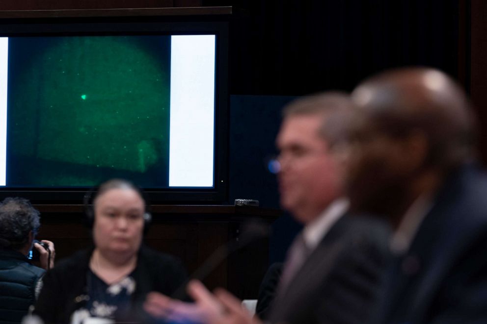 PHOTO: Under Secretary of Defense for Intelligence and Security Ronald Moultrie, right, and Deputy Director of Naval Intelligence Scott Bray speak with a UAP on a screen, during a hearing on Capitol Hill, May 17, 2022, in Washington, D.C.