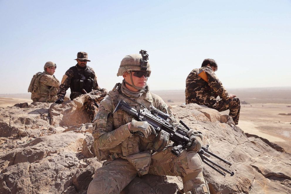 PHOTO: SPC Richard Reilly of Chicago, Illinois and other soldiers with the U.S. Army's 4th squadron 2d Cavalry Regiment patrol with police from Afghanistan's National Defense Service, Feb. 28, 2014 near Kandahar, Afghanistan.