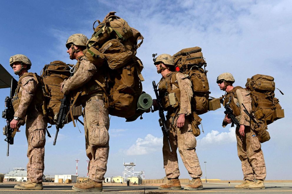 PHOTO: US Marines board a C-130J Super Hercules transport aircraft headed to Kandahar as British and US forces withdraw from the Camp Bastion-Leatherneck complex at Lashkar Gah in Helmand province, Afghanistan, Oct. 27, 2014.