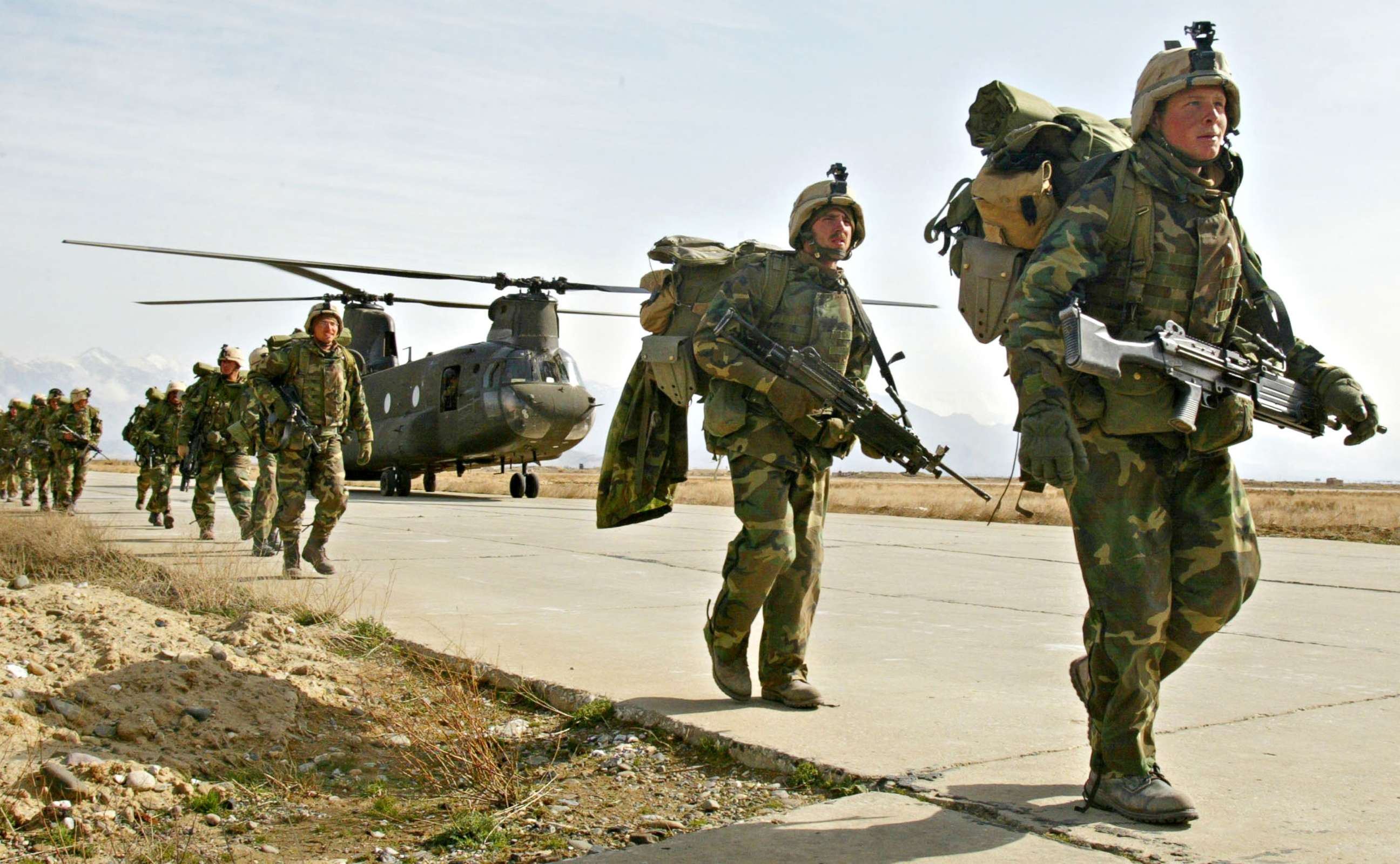 PHOTO: U.S. Army soldiers from the 10th Mountain and the 101st Airborne units disembark from a Chinook helicopter March 11, 2002 as they return to Bagram airbase from the fighting in eastern Afghanistan.