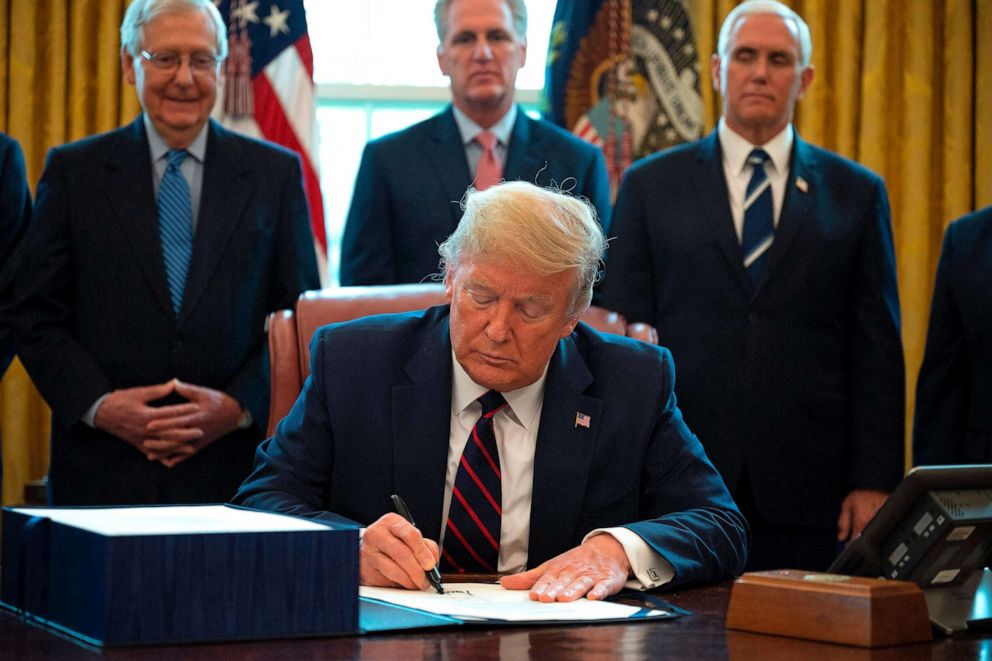 PHOTO: U.S. President Donald Trump signs the National Defense Authorization Act for Fiscal Year 2020 during a ceremony at Joint Base Andrews, Maryland, U.S., on Friday, Dec. 20, 2019.