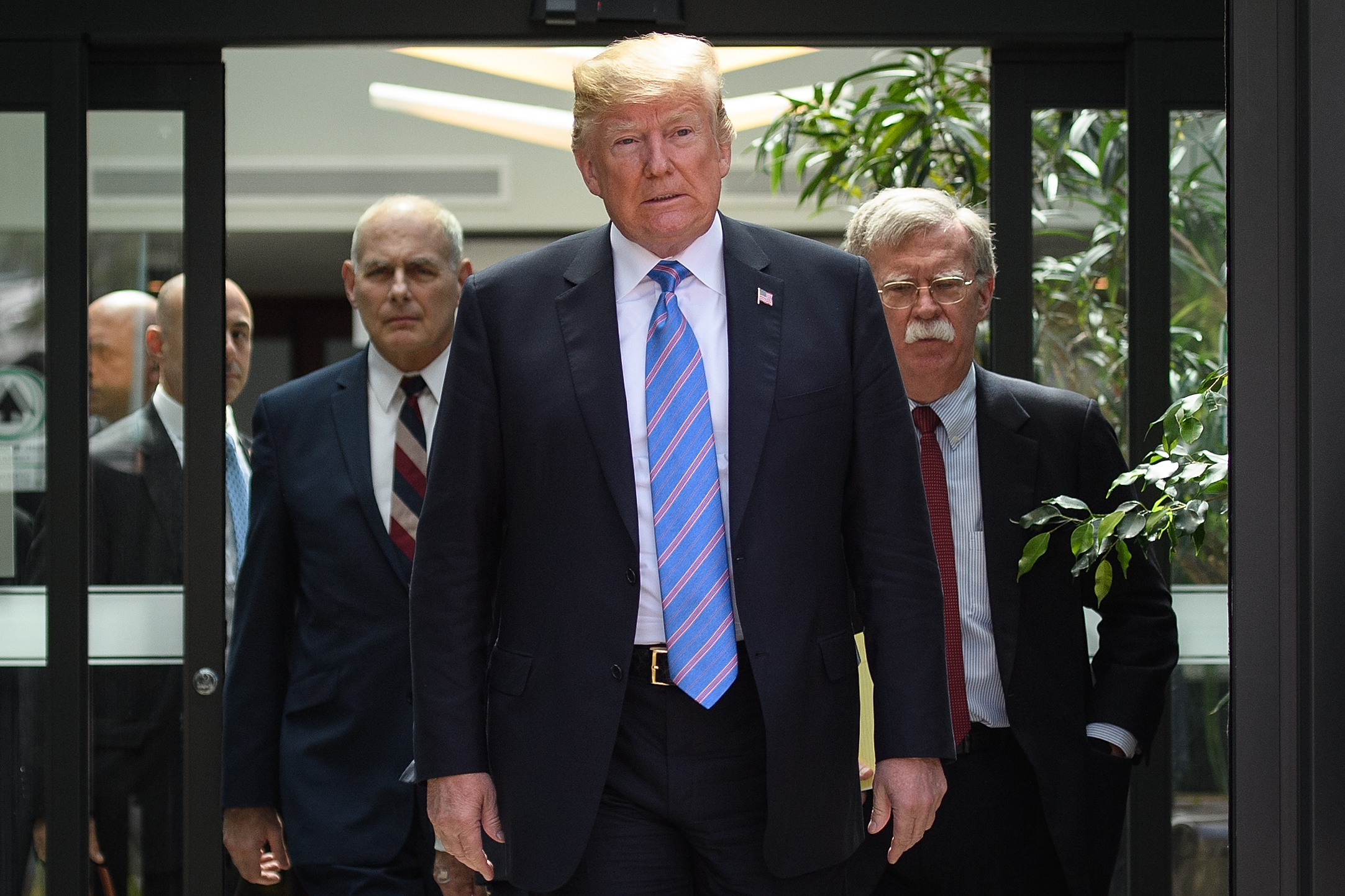 PHOTO: Donald Trump leaves with Chief of Staff John Kelly and National Security Advisor John Bolton after holding a press conference, June 9, 2018 ,in La Malbaie, Canada.