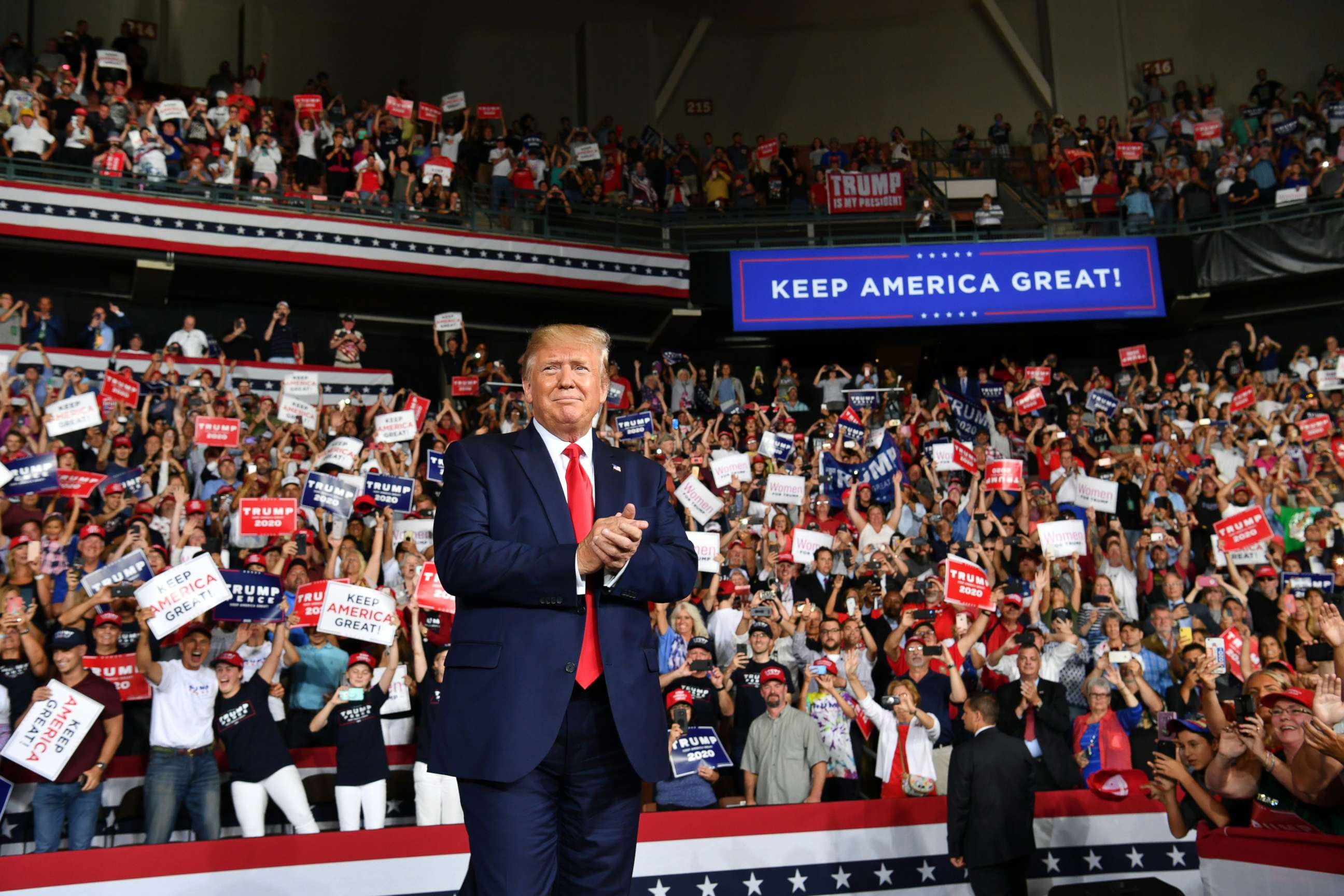 PHOTO: US President Donald Trump salutes his supporters after a "Keep America Great" campaign rally at the SNHU Arena in Manchester, New Hampshire, on August 15, 2019.