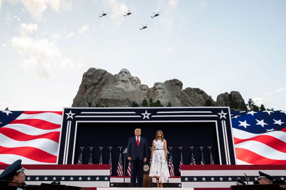 PHOTO: President Donald Trump, accompanied by first lady Melania Trump, stand during a flyover at Mount Rushmore National Memorial, Friday, July 3, 2020, near Keystone, S.D.