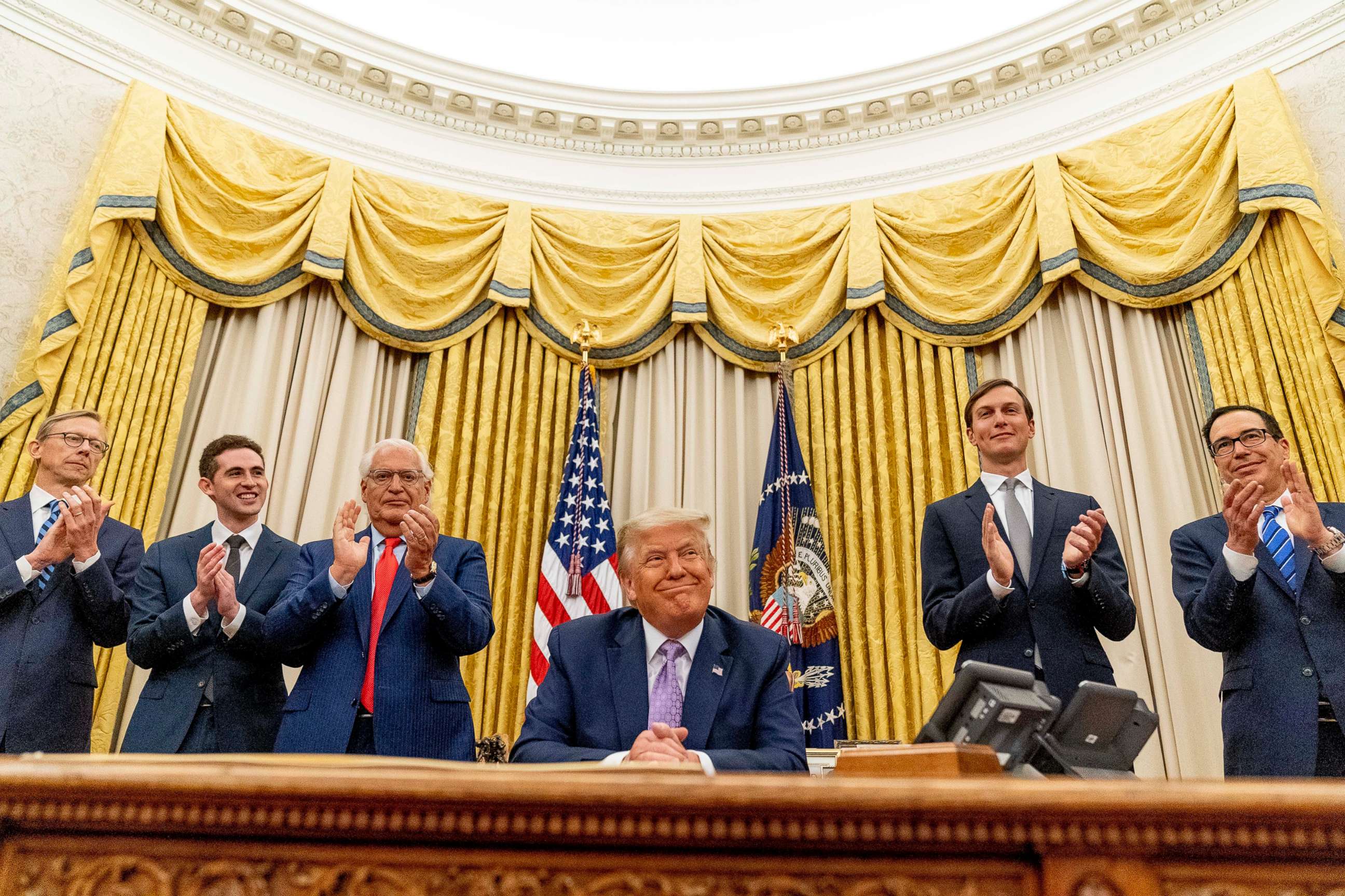 PHOTO: President Donald Trump smiles in the Oval Office at the White House, Aug. 13, 2020.