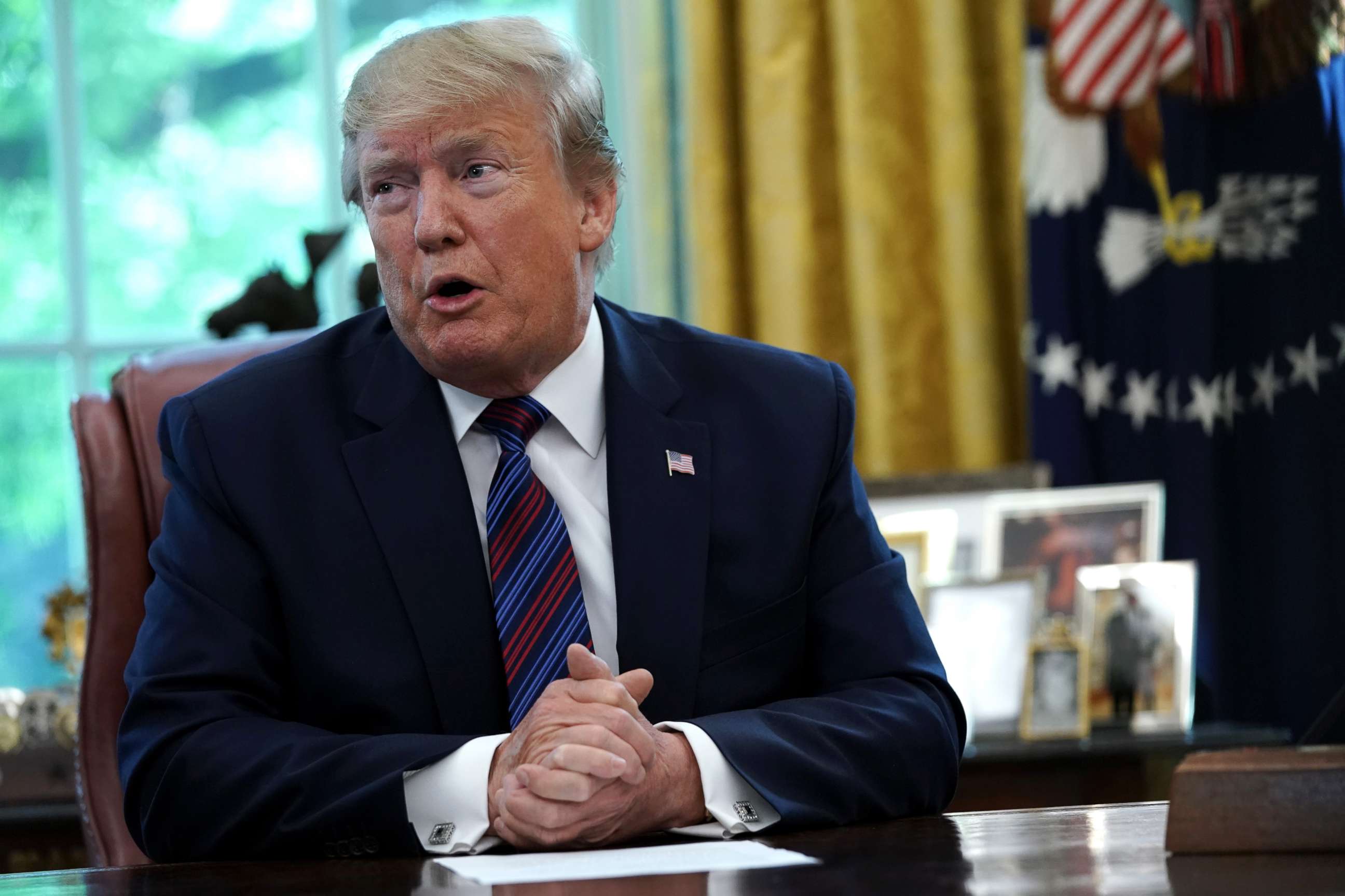 PHOTO:President Donald Trump speaks to members of the press during a signing of a safe third country agreement in the Oval Office, July 26, 2019.