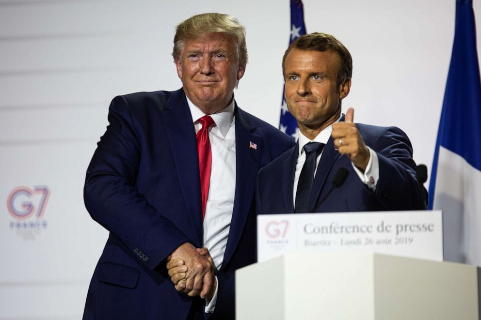 PHOTO: President Donald Trump and French President Emmanuel Macron join hands during the final press conference of the G7 Summit, Aug. 26, 2019, in Biarritz, France. 