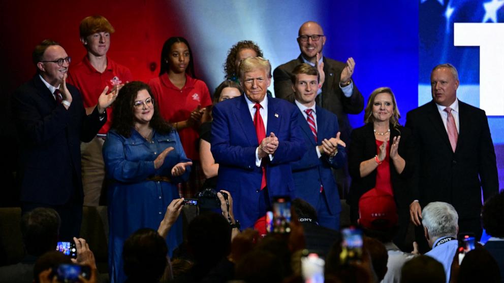 PHOTO: Former President and Republican presidential candidate Donald Trump applauds during a "Believers and Ballots Faith" Town Hall event in Zebulon, Ga., Oct. 23, 2024. 