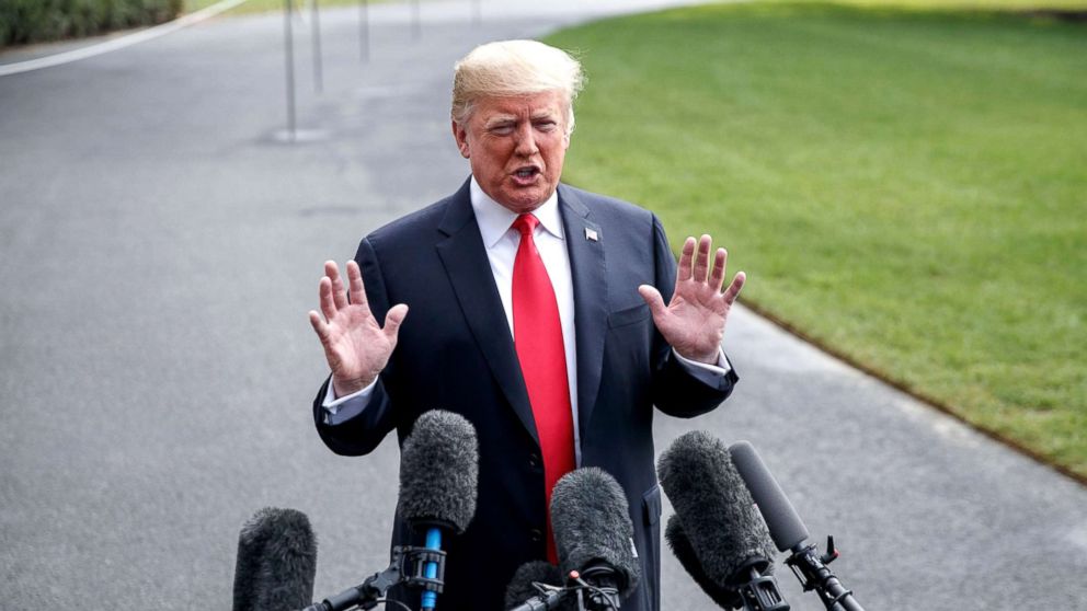 President Donald Trump responds to a question from the media as he walks to board Marine One on the South Lawn of the White House, Oct. 8, 2018.