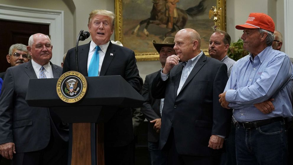 PHOTO: President Donald Trump delivers remarks in support of farmers and ranchers with Agriculture Secretary Sonny Perdue (2nd L) in the Roosevelt Room at the White House, May 23, 2019.