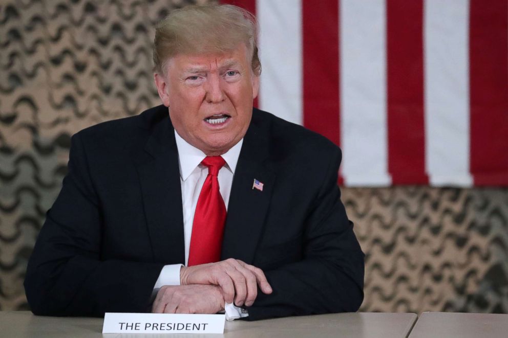 PHOTO: President Donald Trump speaks to reporters before he meets political and military leaders during an unannounced visit to Al Asad Air Base in Iraq, Dec. 26, 2018.