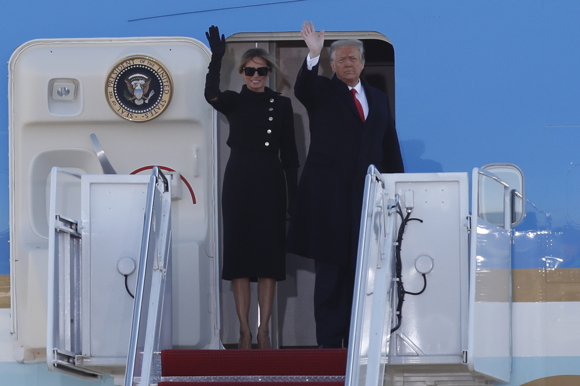 PHOTO: President Donald Trump and first lady Melania Trump wave to a crowd as they board Air Force One at Andrews Air Force Base, Md., Jan. 20, 2021.