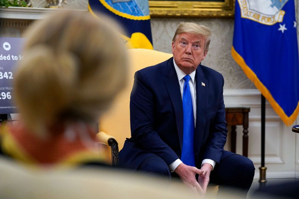 PHOTO: President Donald Trump listens during a meeting with Gov. Kim Reynolds, R-Iowa, in the Oval Office of the White House, May 6, 2020, in Washington. 