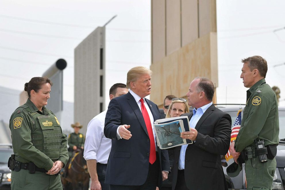 PHOTO: US President Donald Trump (C) is shown border wall prototypes in San Diego, California on March 13, 2018. / AFP PHOTO / MANDEL NGAN        (Photo credit should read MANDEL NGAN/AFP via Getty Images)