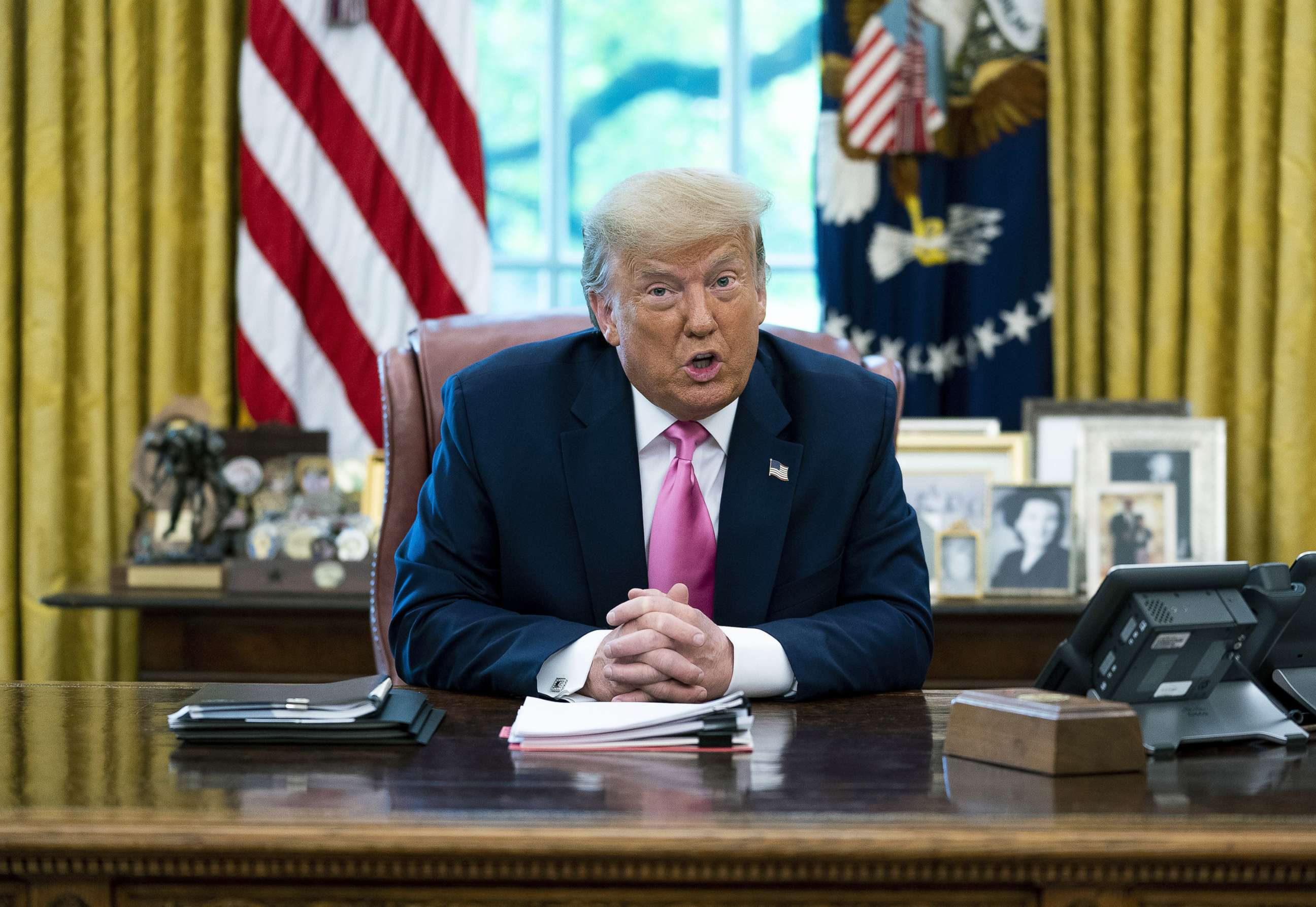 PHOTO: President Donald Trump talks to reporters while hosting Republican Congressional leaders and members of his cabinet in the Oval Office at the White House July 20, 2020.
