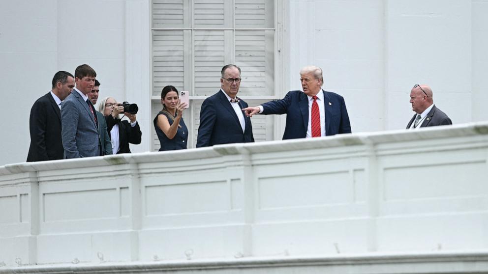 PHOTO: President Donald Trump surveys the grounds from a rooftop at the White House, Aug. 5, 2025.