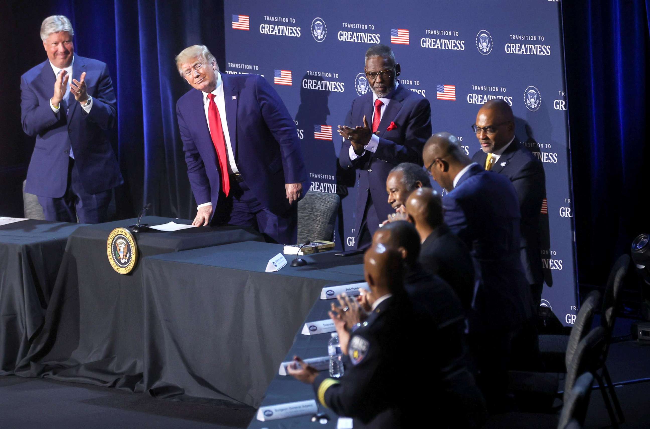 PHOTO: President Donald Trump watches as Secretary of Housing and Urban Development Ben Carson gets a standing ovation.