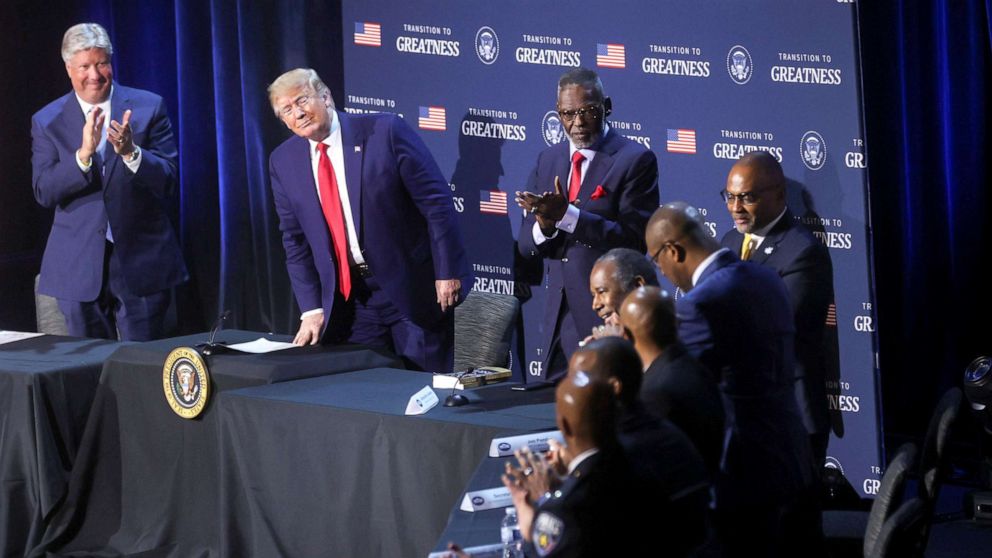 PHOTO: President Donald Trump watches as Secretary of Housing and Urban Development Ben Carson gets a standing ovation.