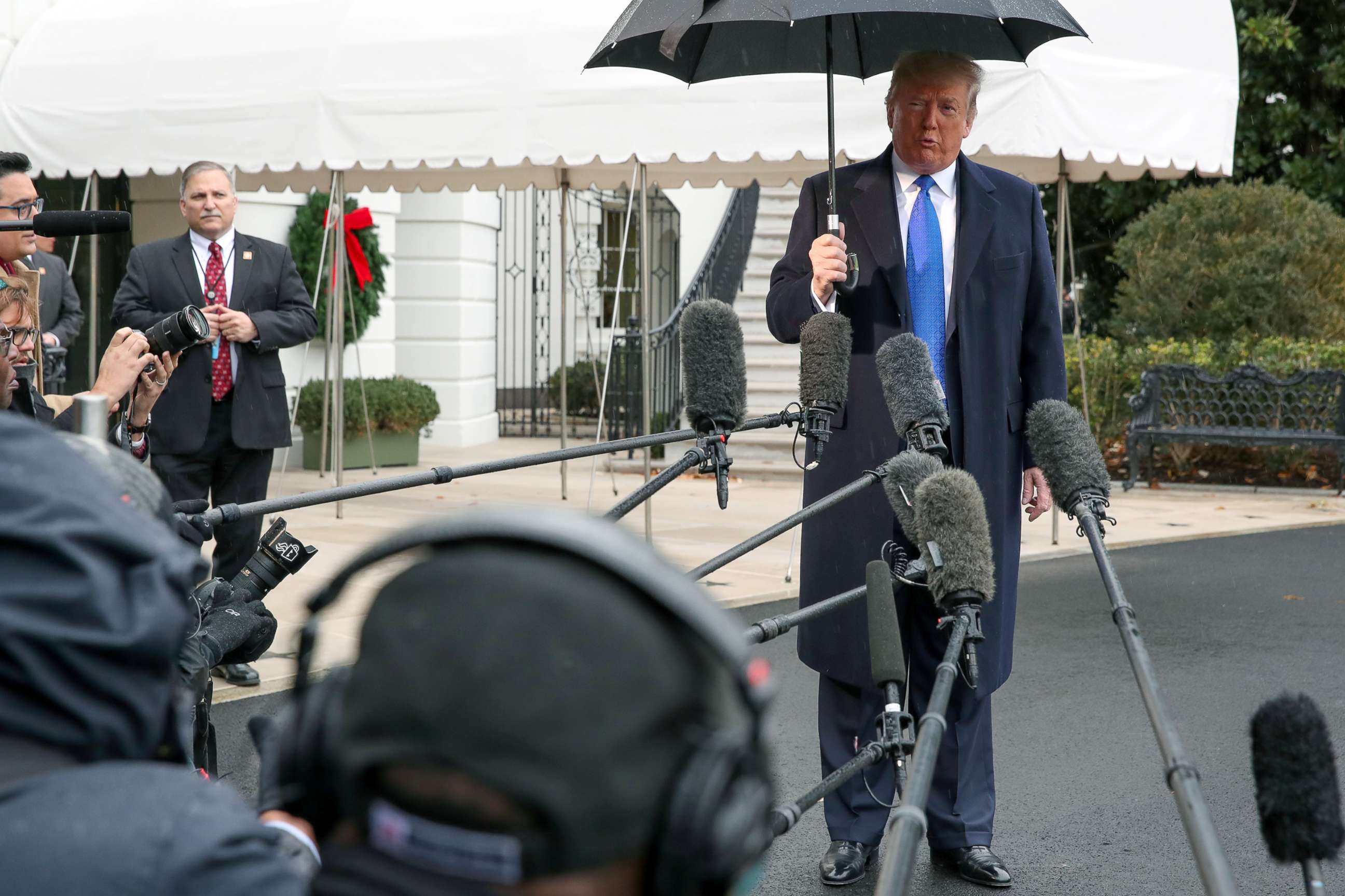 PHOTO: President Donald Trump speaks to reporters as he and first lady Melania Trump depart for travel to a NATO summit in London, Dec. 2, 2019. 