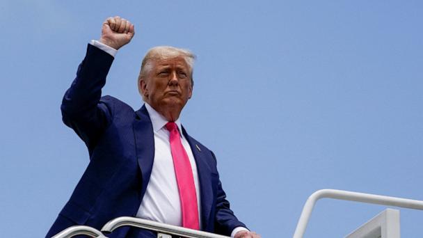 President Donald Trump raises his fist while boarding Air Force One, as he departs for Pennsylvania, at Joint Base Andrews, Md., July 15, 2025. 