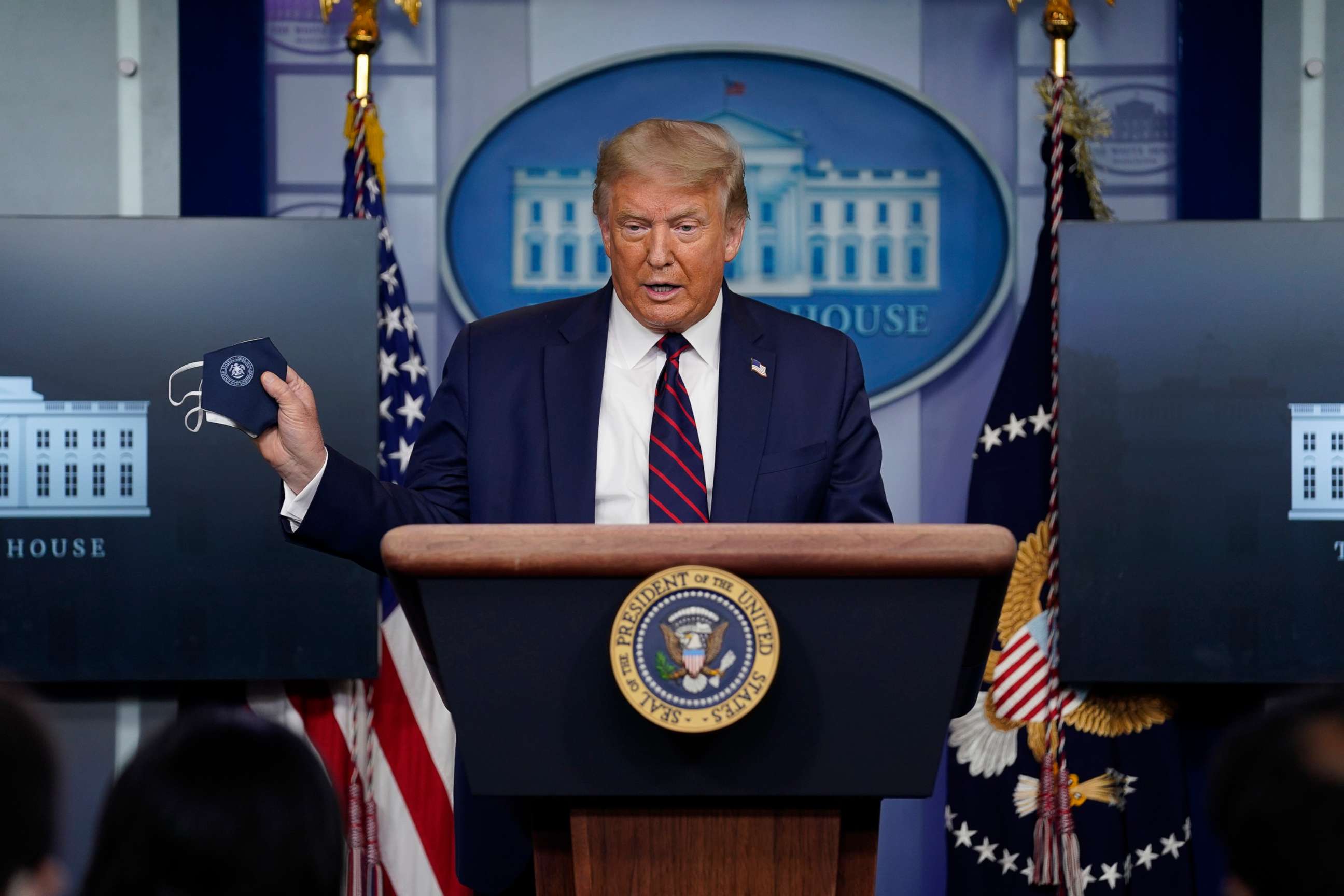 PHOTO: President Donald Trump holds a face mask as he speaks during a news conference at the White House, July 21, 2020.