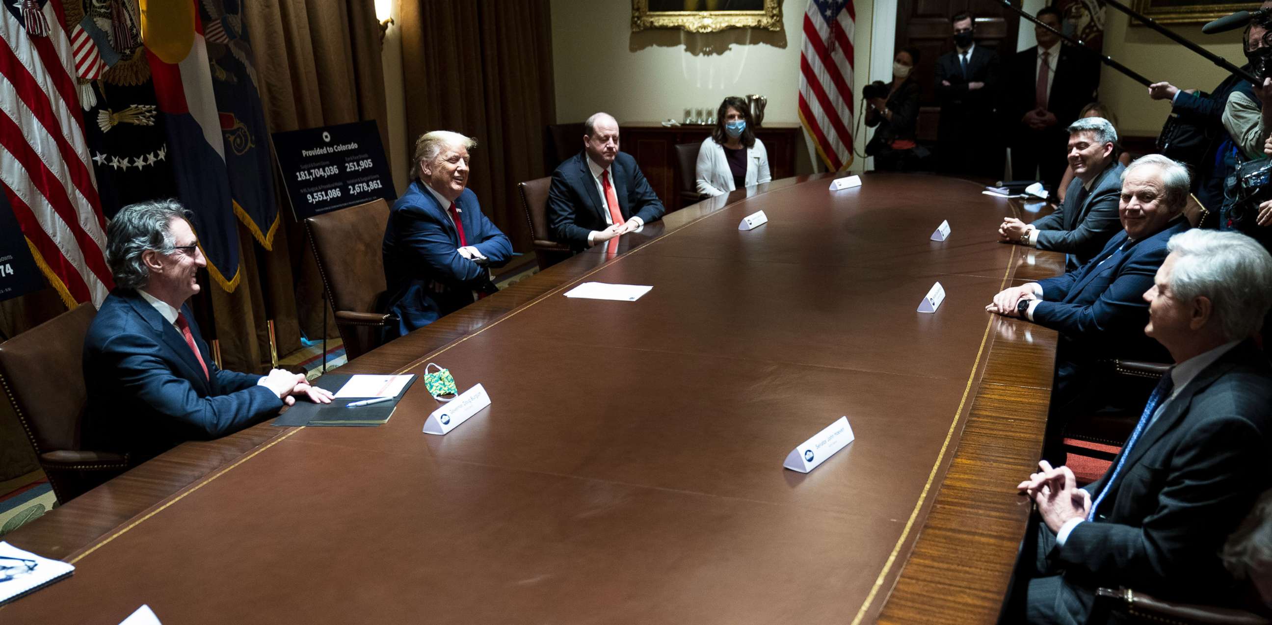 PHOTO: North Dakota Governor Doug Burgum, President Donald Trump and Colorado Governor Jared Polis meet in the Cabinet Room of the White House, May 13, 2020. 
