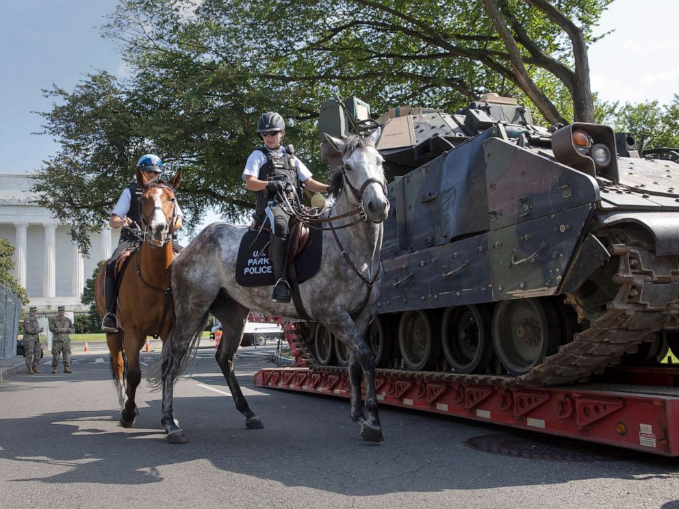 PHOTO: Mounted US Park Police pass by an armored Bradley Fighting Vehicle near the Lincoln Memorial as preparations continue for Independence Day celebrations on the National Mall in Washington, D.C., July 3, 2019.