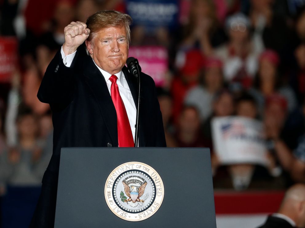 PHOTO: President Donald Trump fires his fist by leaving the scene after speaking to supporters at a rally at the Southern Illinois Airport in Murphysboro, Illinois on October 27, 2018.