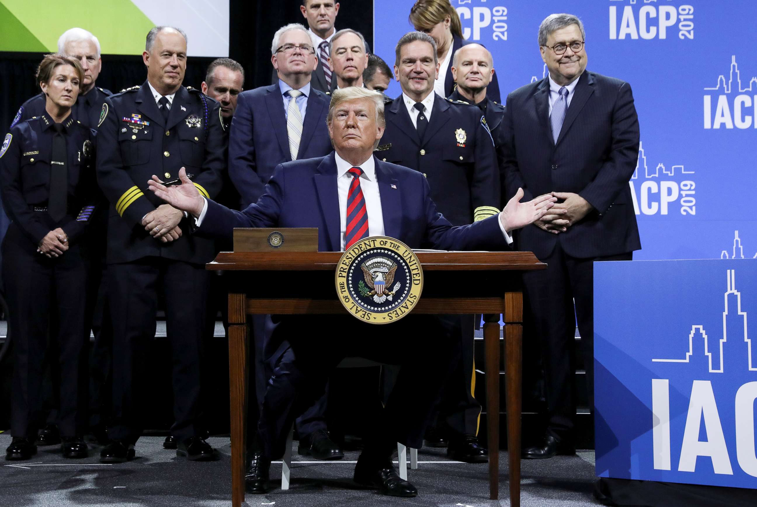 PHOTO: President Donald Trump reacts after signing an executive order during an appearance at the International Association of Chiefs of Police annual conference and expo in Chicago, Oct. 28, 2019. 