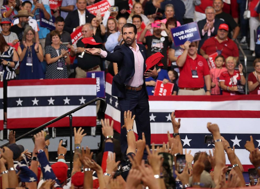 PHOTO: Eric Trump tosses campaign hats to the crowd before his father, United States President Donald Trump, arrives on stage to announce his candidacy for a second presidential term at the Amway Center, June 18, 2019,  in Orlando, Fla.