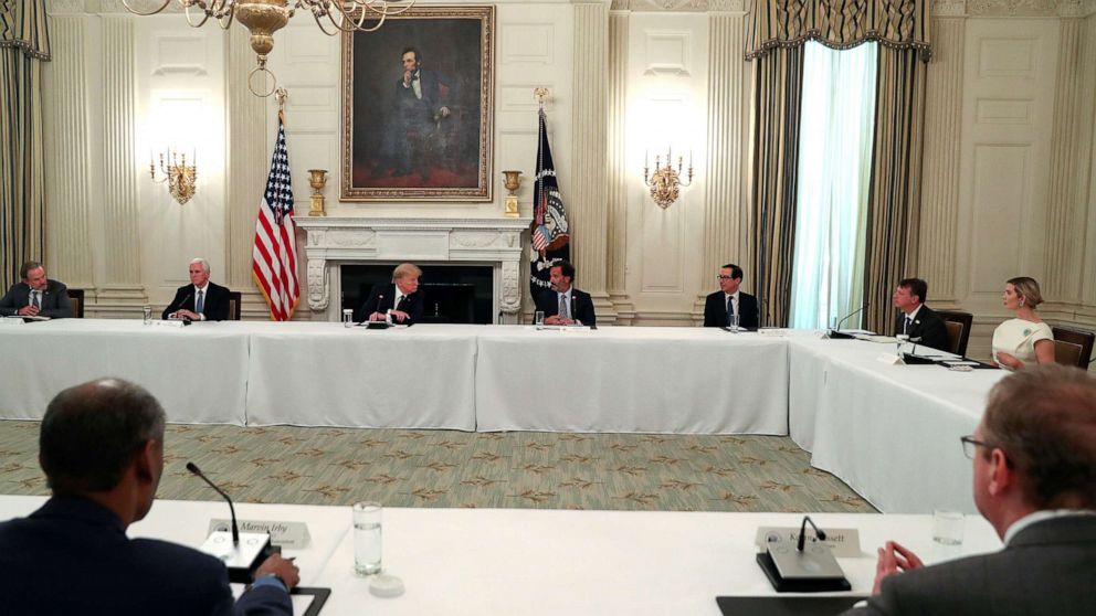 PHOTO: President Donald Trump speaks with restaurant executives and industry leaders during a coronavirus disease (COVID-19) pandemic meeting in the State Dining Room at the White House, May 18, 2020. 