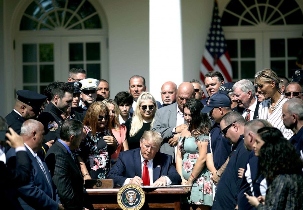 PHOTO: Surrounded by first responders and their families, President Donald Trump signs H.R. 1327, an act to permanently authorize the September 11th victim compensation fund, in the Rose Garden of the White House, July 29, 2019.