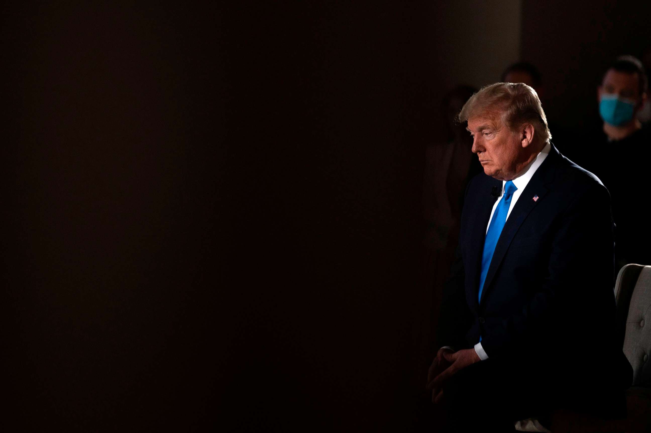 PHOTO: President Donald Trump sits during a commercial break of a Fox News virtual town hall "America Together: Returning to Work," event from the Lincoln Memorial in Washington, DC., on May 3, 2020.