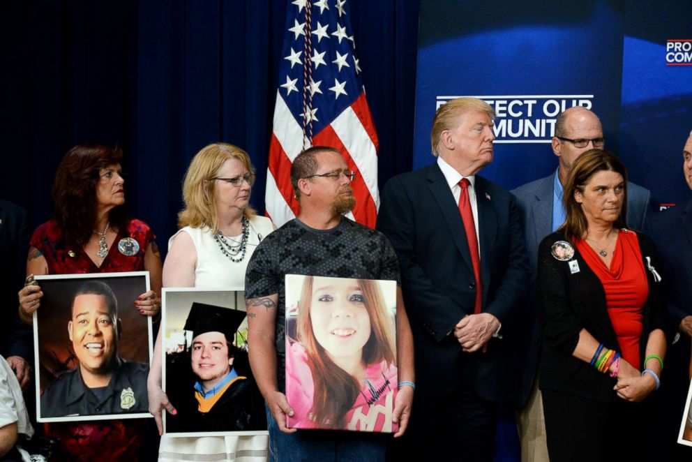 PHOTO: President Donald Trump stands alongside family members affected by crime committed by undocumented immigrants at the South Court Auditorium on the White House complex, June 22, 2018, in Washington.
