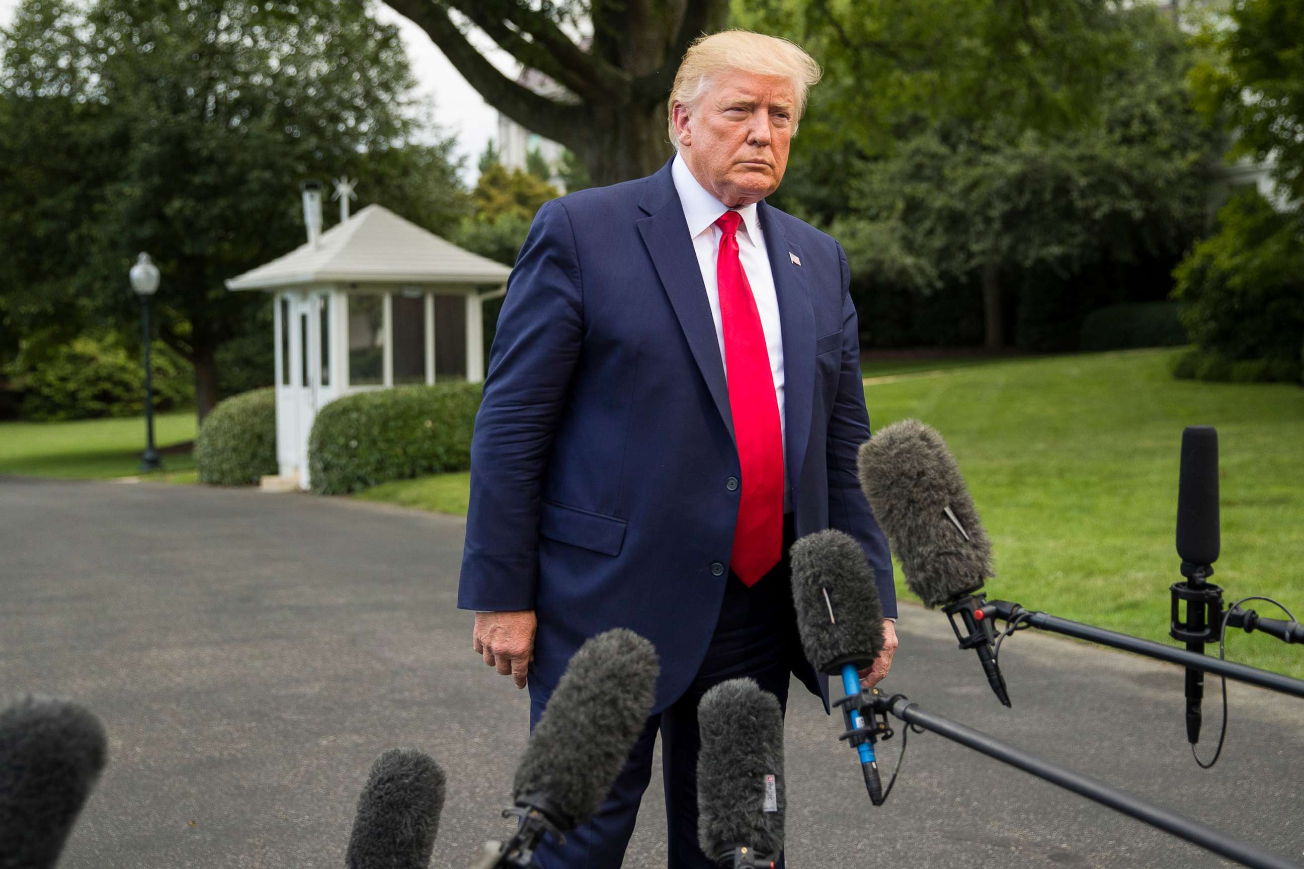 PHOTO: President Donald Trump listens to a question as he speaks with reporters on the South Lawn of the White House before departing, July 17, 2019, in Washington.