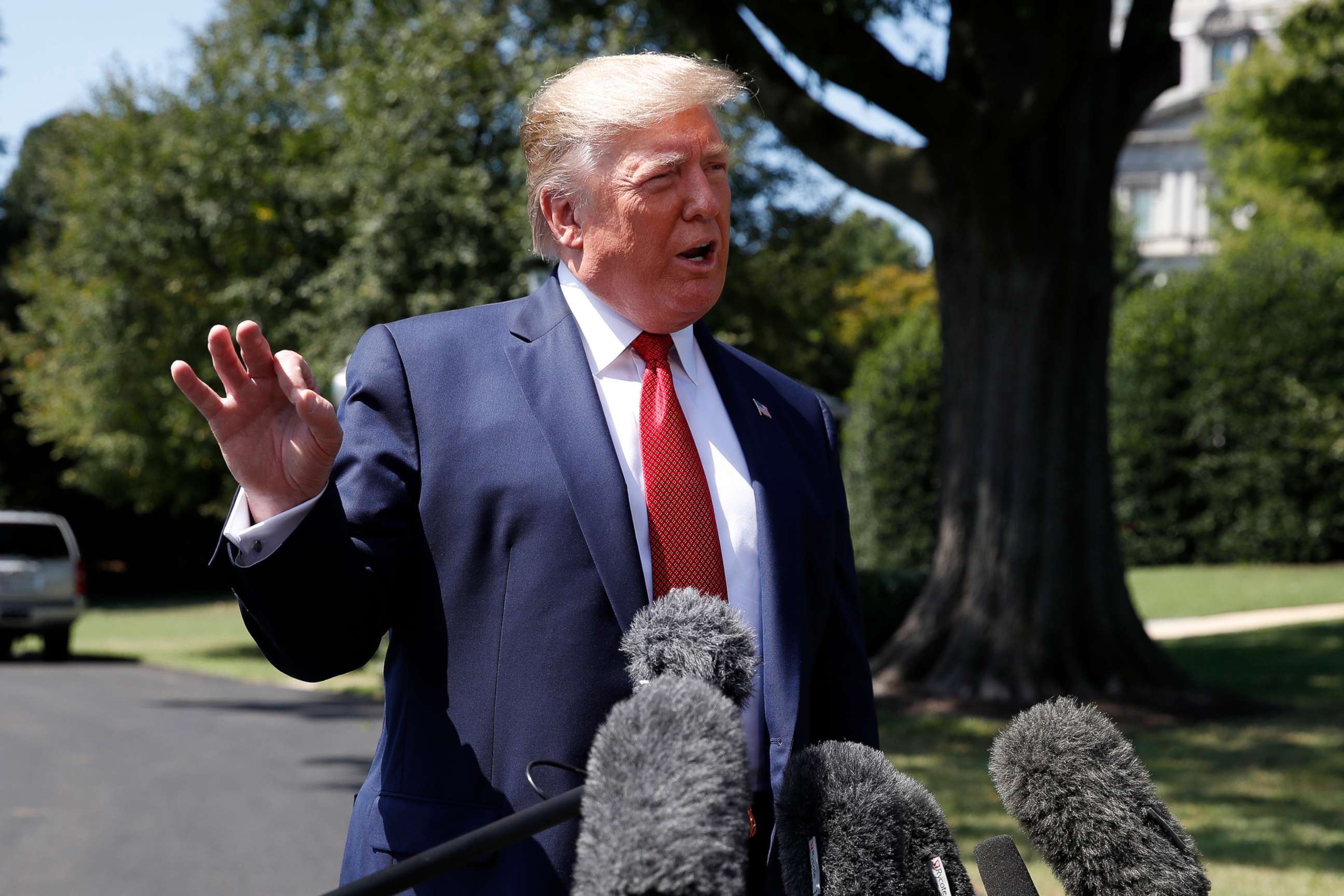 PHOTO: President Donald Trump speaks with reporters before departing on Marine One on the South Lawn of the White House, Wednesday, Aug. 21, 2019, in Washington.