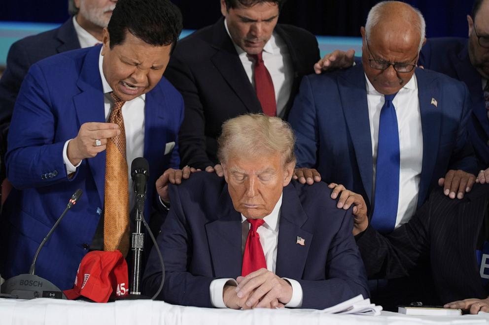 PHOTO: Latino leaders pray with Republican presidential nominee former President Donald Trump as he participates in a Latino leader roundtable, Oct. 22, 2024 in Doral, Fla. 