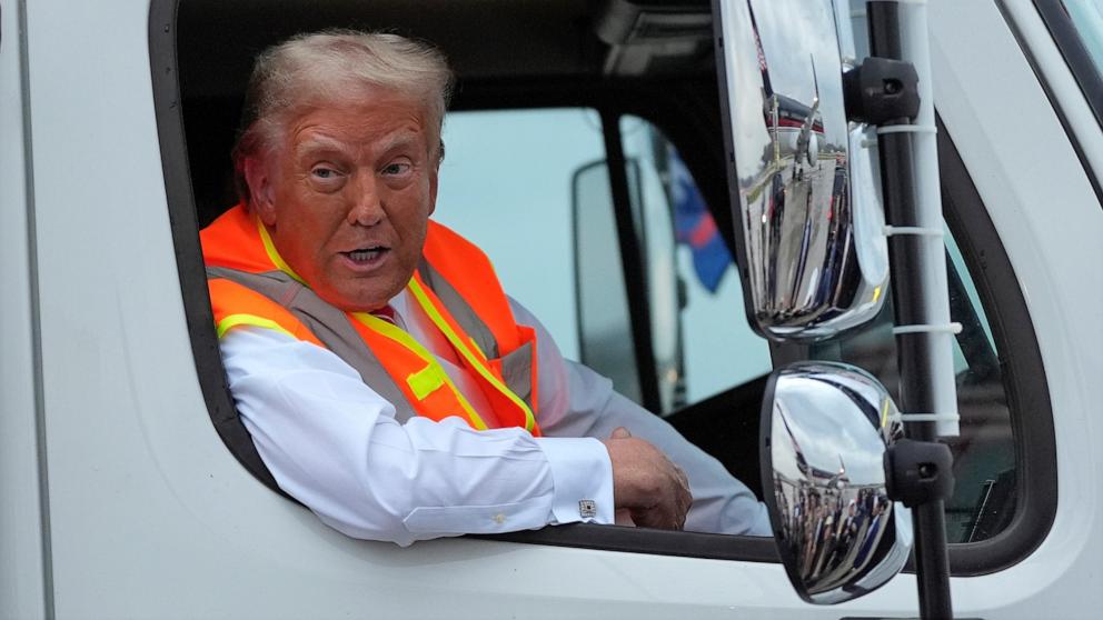 PHOTO: Republican presidential nominee former President Donald Trump talks to reporters as he sits in a garbage truck, Oct. 30, 2024, in Green Bay, Wis. 