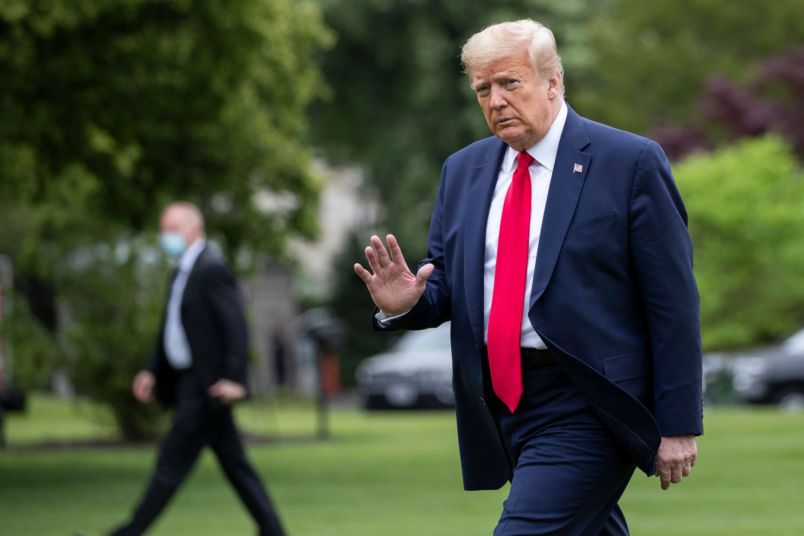 PHOTO: President Donald Trump waves as he walks across the South Lawn of the White House on Marine One, Sunday, May 17, 2020, in Washington. Trump was returning from nearby Camp David, Md.