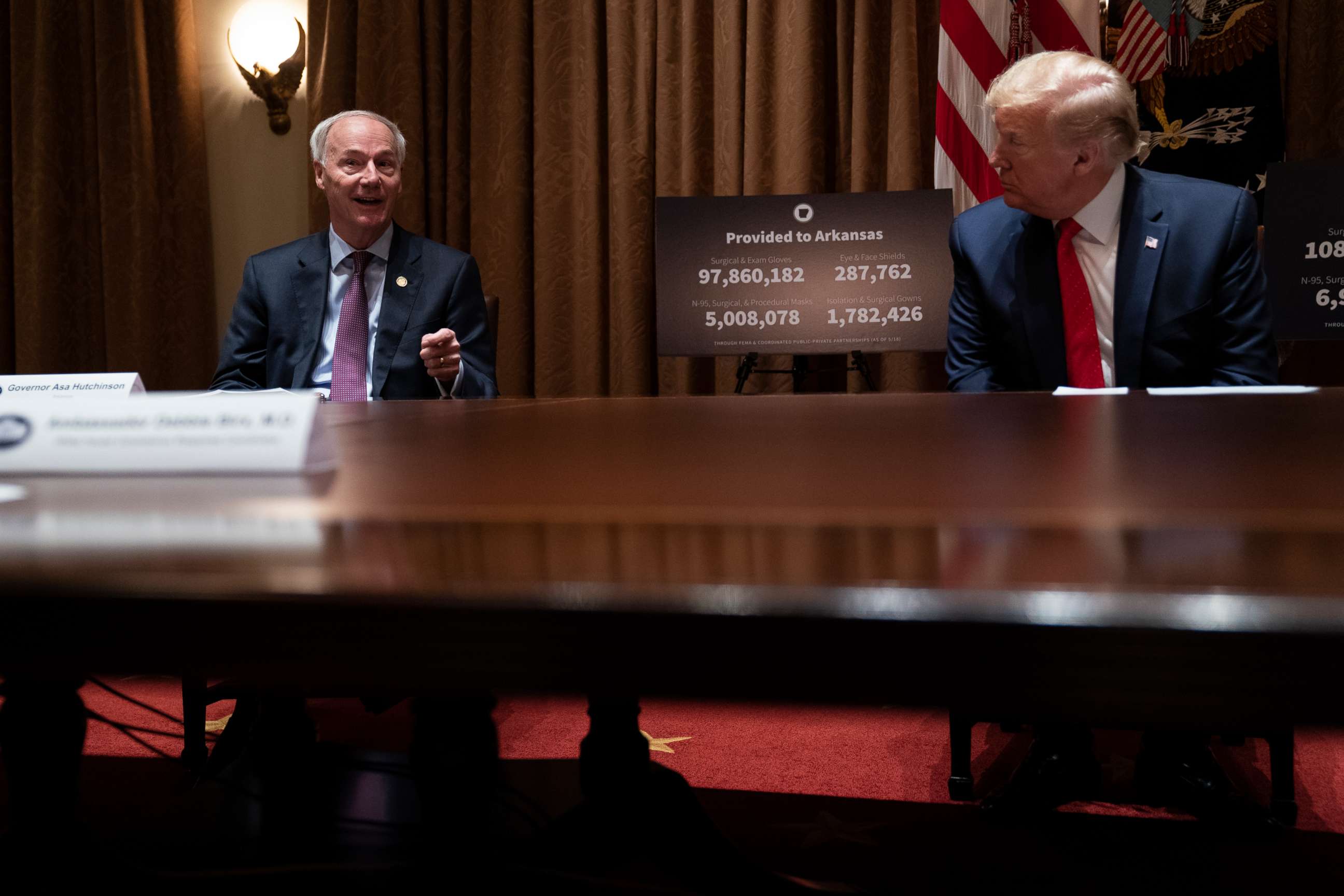 PHOTO: President Donald Trump listens as Arkansas Gov. Asa Hutchinson speaks during a meeting in the Cabinet Room of the White House, May 20, 2020, in Washington. 