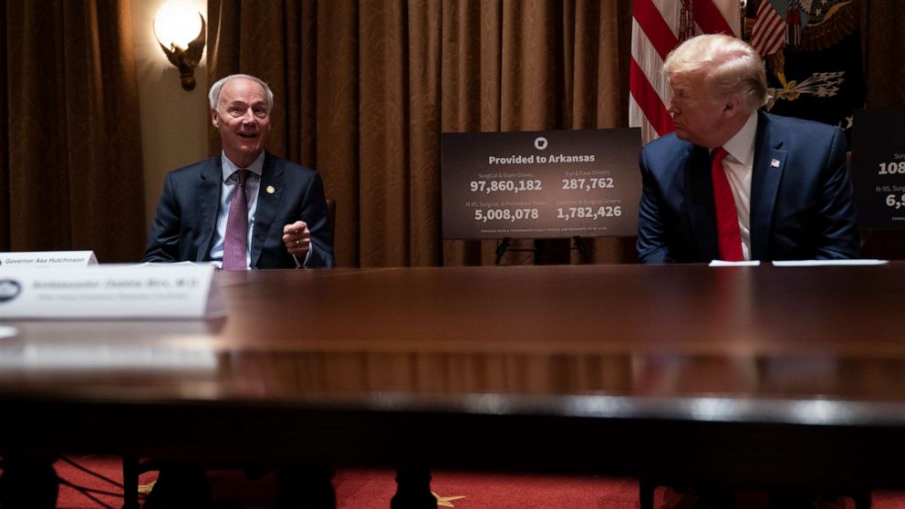 PHOTO: President Donald Trump listens as Arkansas Gov. Asa Hutchinson speaks during a meeting in the Cabinet Room of the White House, May 20, 2020, in Washington. 
