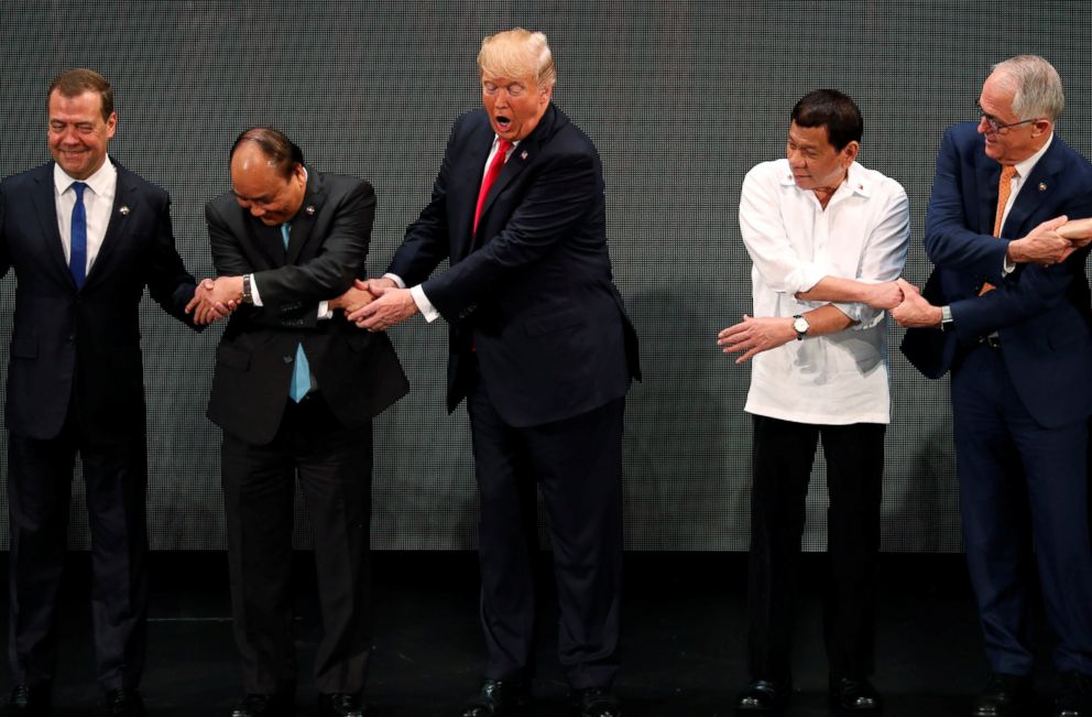 PHOTO: President Donald Trump participates in traditional "ASEAN handshake" with other leaders at the opening ceremony of the ASEAN Summit in Manila, Philippines, Nov. 13, 2017.