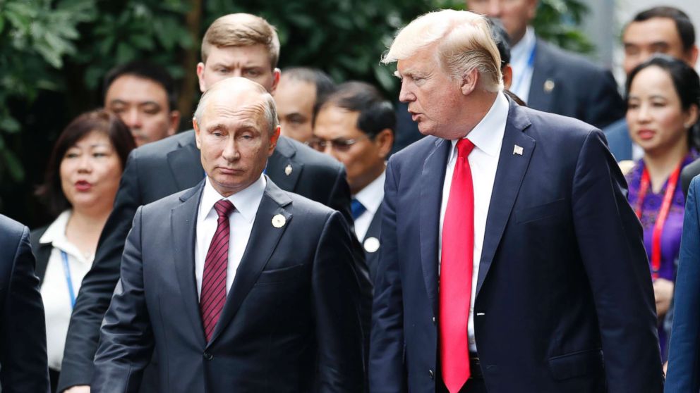 President Donald Trump, right, and Russia's President Vladimir Putin talk during the family photo session at the APEC Summit in Danang, Vietnam, Nov. 11, 2017.  