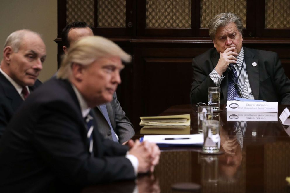 PHOTO: White House Chief Strategist Steve Bannon, right,  listens to President Donald Trump at the beginning of a meeting with government cyber security experts in the Roosevelt Room at the White House Jan. 31, 2017.