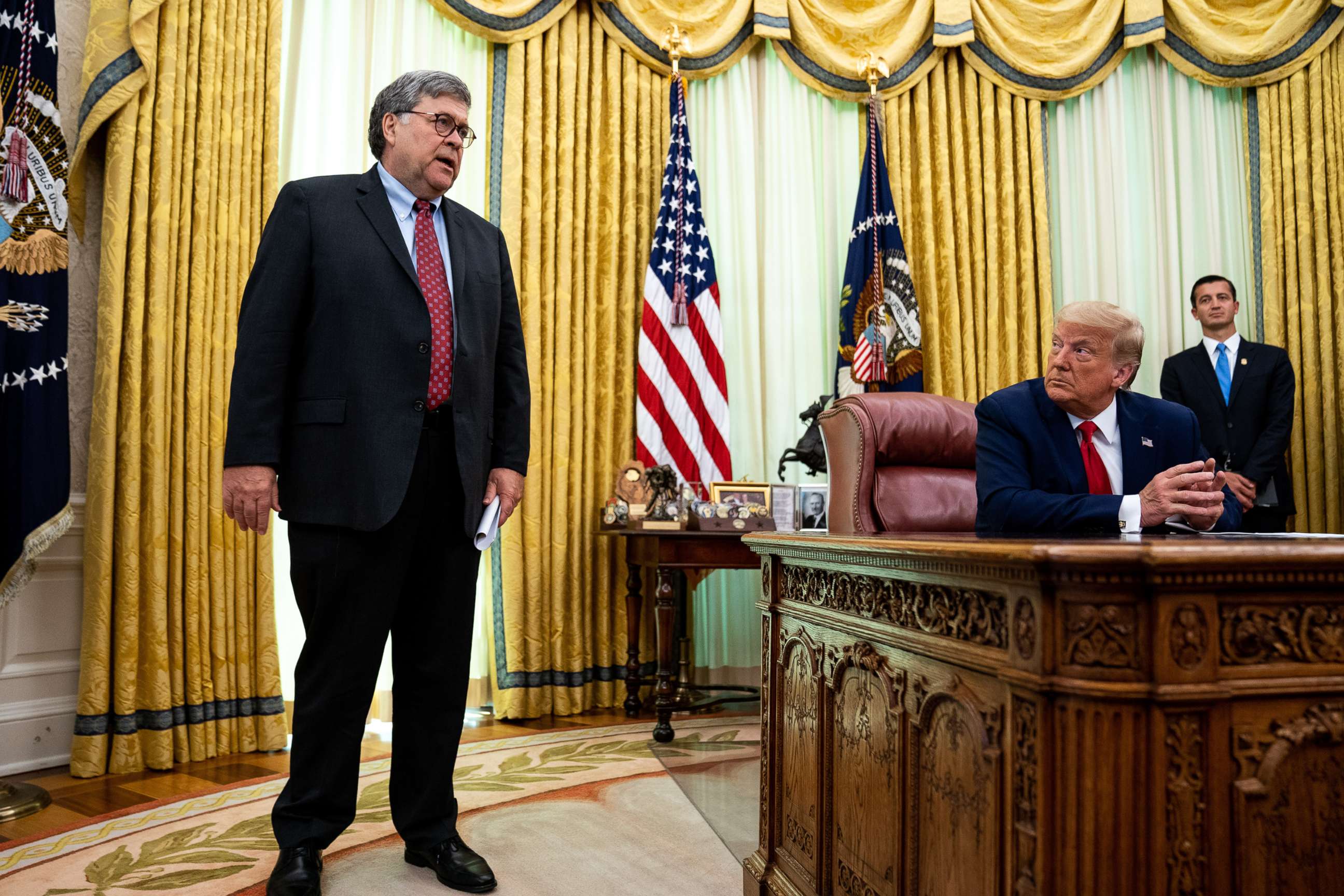 PHOTO: Attorney General William Barr speaks as President Donald Trump listens in the Oval Office of the White House after receiving a briefing on July 15, 2020, in Washington, DC.
