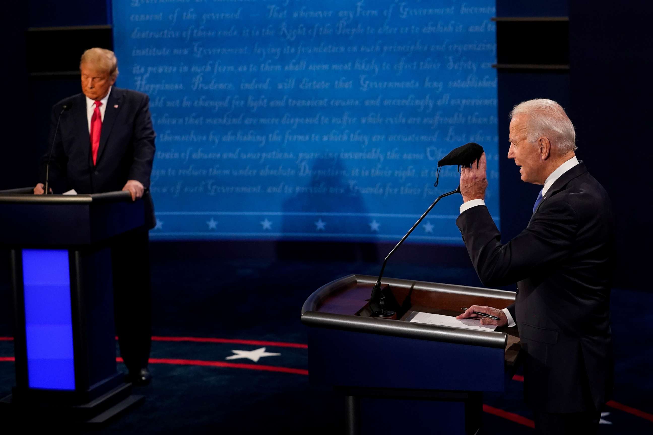 PHOTO: Former Vice President Joe Biden holds up a mask as President Donald Trump takes notes during the second and final presidential debate at the Curb Event Center at Belmont University in Nashville, Tenn., Oct. 22, 2020.