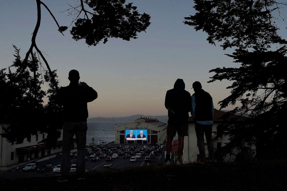 PHOTO: People watch from a hill as President Donald Trump and former Vice President Joe Biden speak during a Presidential Debate Watch Party at Fort Mason Center in San Francisco, Oct. 22, 2020.