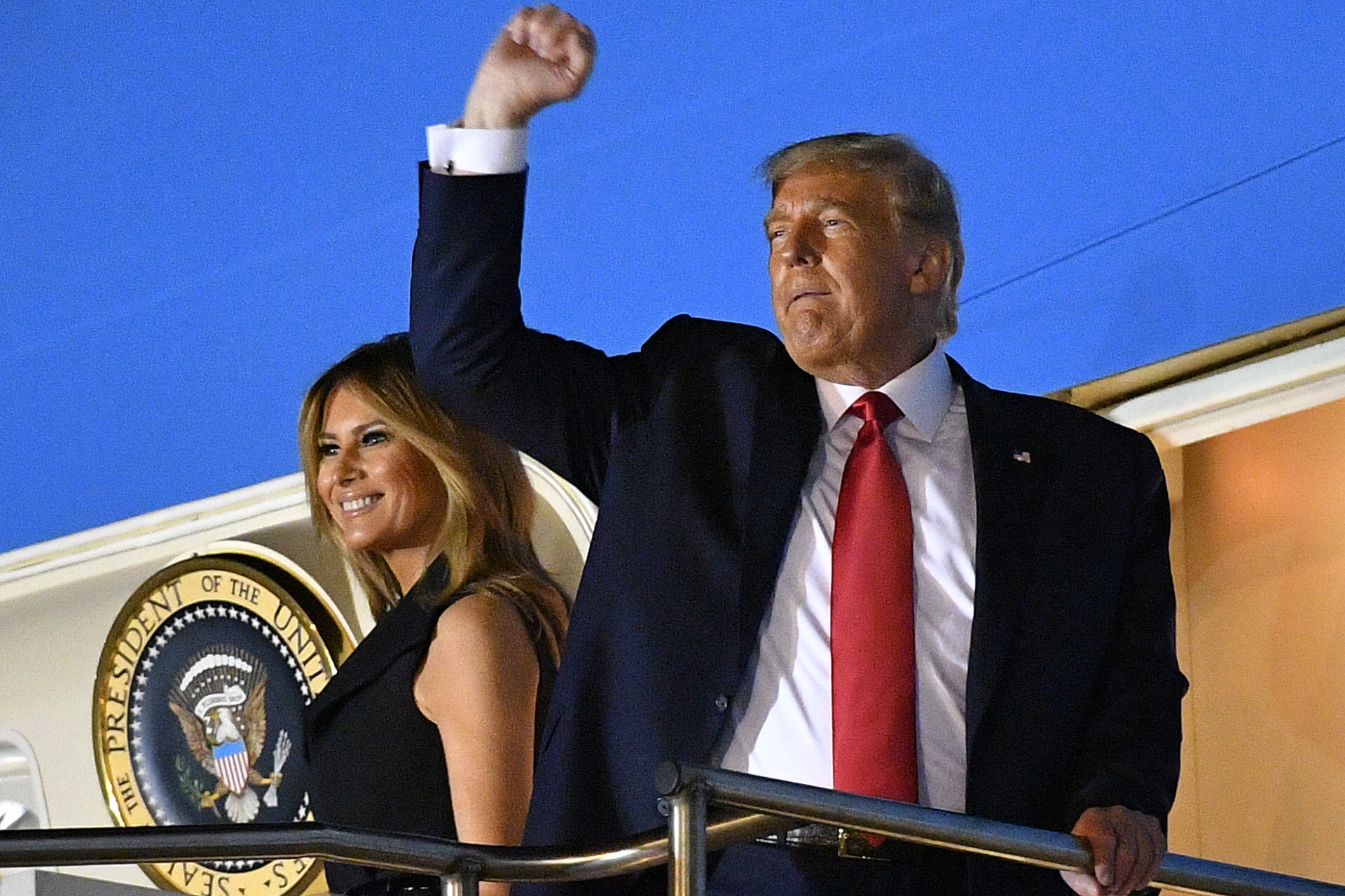 PHOTO: President Donald Trump raises his fist as he and first lady Melania Trump board Air Force One to depart Nashville International Airport after the final presidential debate in Nashville, Tenn., Oct. 22, 2020.