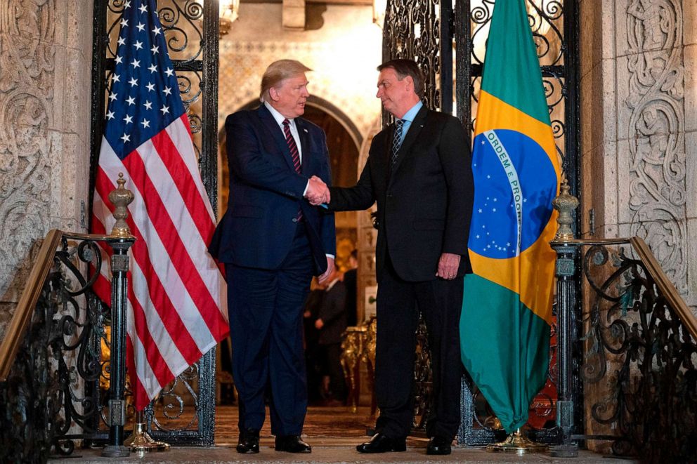 PHOTO: President Donald Trump shakes hands with Brazilian President Jair Bolsonaro during a diner at Mar-a-Lago in Palm Beach, Fla., March 7, 2020.